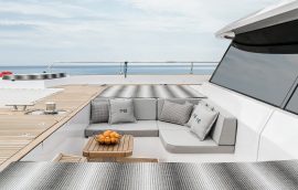 Bow deck with large cushioned sofa on catamaran Sunreef 60