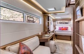 Master cabin with double bed, leisure sofa and working table on lagoon 50